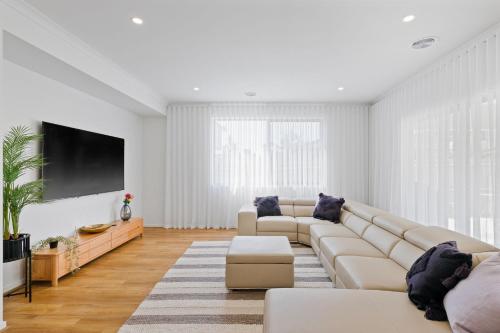 a living room with a couch and a tv at Paterson Retreat in San Remo