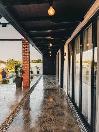 an empty hallway of a building with windows at Calma Villa @ Pendang in Pendang
