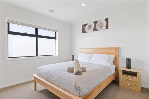 a bedroom with a large bed and a window at Paterson Retreat in San Remo