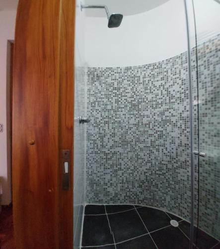 a bathroom with a shower with a glass door at Casa Palermo Manizales in Manizales
