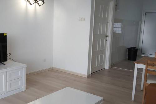 an empty living room with a table and a door at Silverpar B5-5-1 Mountain View(walk up 2 floor up) in Bukit Fraser