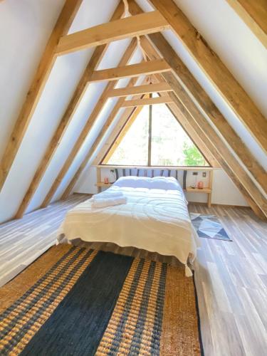 a bedroom with a bed in the attic at Cabañas Ladera Sur in Melipeuco