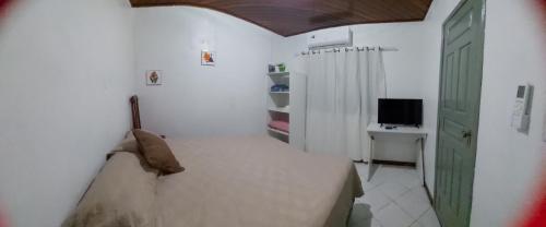 - une petite chambre avec un lit et une télévision dans l'établissement Suíte com ar condicionado próximo ao Estádio Mangueirão, à Belém