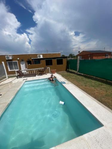 a swimming pool with a person in the water at Cab,SE,1,2 in Villa Los Aromos