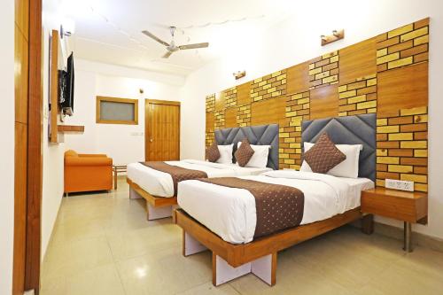 a bedroom with four beds in a room at Hotel Ambrosia - A Boutique Hotel in New Delhi
