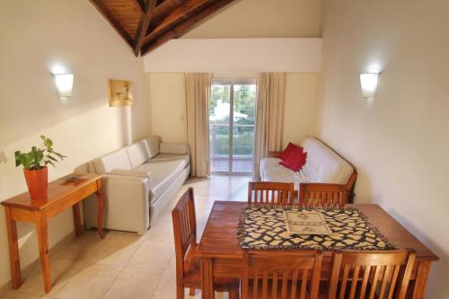 a living room with a table and a couch at Hotel El Sauce in Santa Rosa de Calamuchita