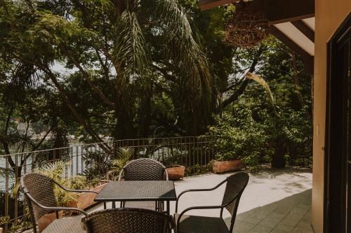 a table and chairs on a patio with trees at Las Haditas in Chiapa de Corzo