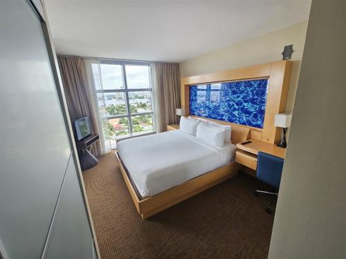 a hotel room with a bed and a large window at Mare-1708 A in Aventura