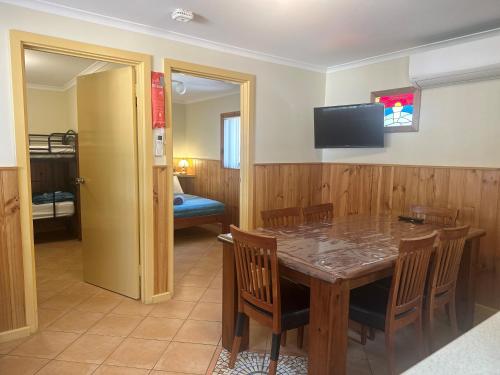 a dining room with a table and chairs and a television at Ceduna Shelly Beach Caravan Park in Ceduna