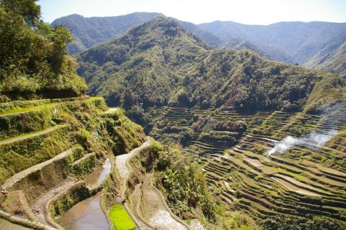 an aerial view of a valley with mountains in the background at Hiker's Homestay in Banaue