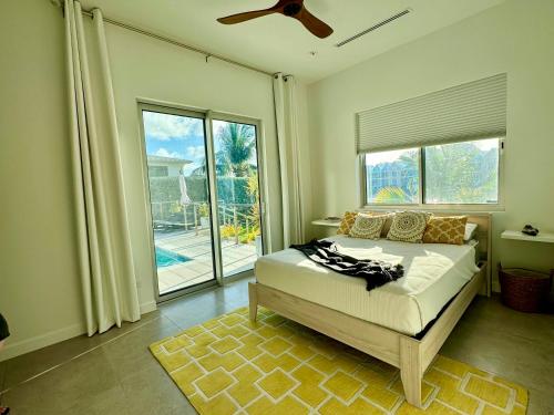 a bedroom with a bed and a large window at Villa Olea in George Town