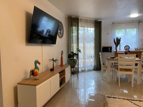 a living room with a tv on the wall at F2 St Denis Jardin d'état in Saint-Denis