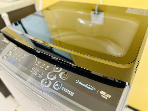 a close up of a toaster oven with a microwave at Urban Suite Spacious 2 or 3 Bedroom and 2Bathroom at Georgetown by URBAN STAYCATION HENG LOD in Jelutong