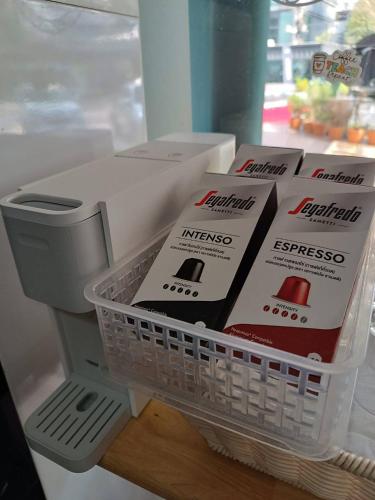 a shelf in a refrigerator with a basket of pizza boxes at Room@Doze in Nonthaburi