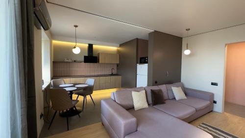 a living room and kitchen with a couch and a table at 2 room Modern Apartment in Dnipro