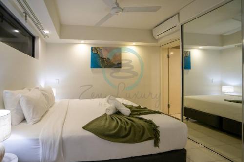 a bedroom with a bed with a towel on it at Zen Ocean Pebble 1-BR/1-BA Sea View Retreat in Darwin