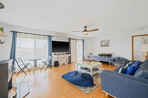 a living room with a couch and a table at Old Sea Dog's Retreat in Coronet Bay