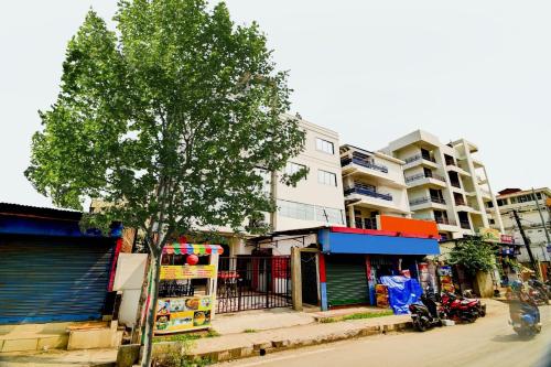 a city street with a tree and a building at Hotel O Home Cozy Home in Guwahati