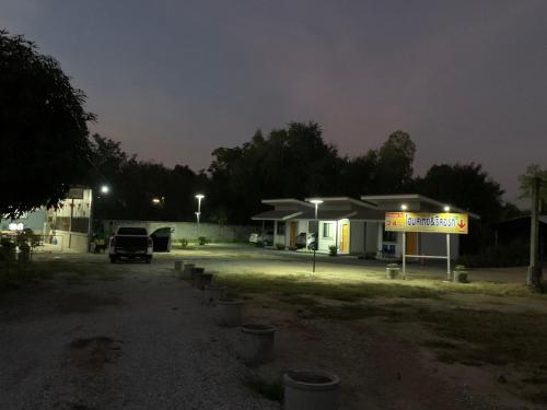 a gas station at night with a sign in front at KHUN CHUAT'S HOUSE in Ban Nong Ben