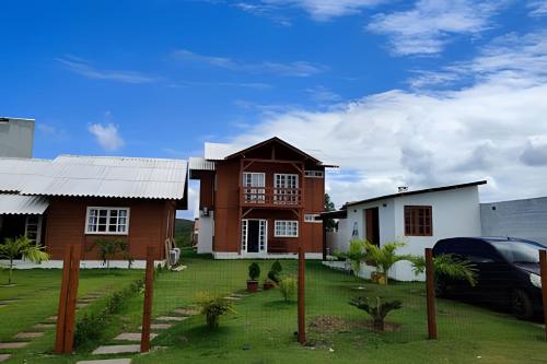 a house with a car parked in front of it at Recanto Arvoredo in Entre Rios