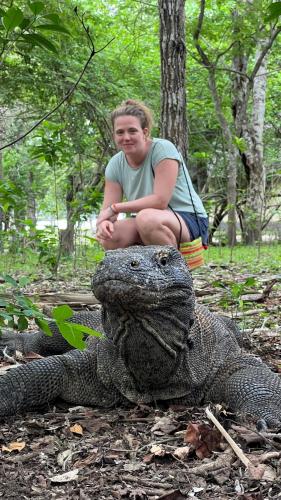 a woman is sitting on top of an alligator at Jhuna Komodo Homestay in Komodo