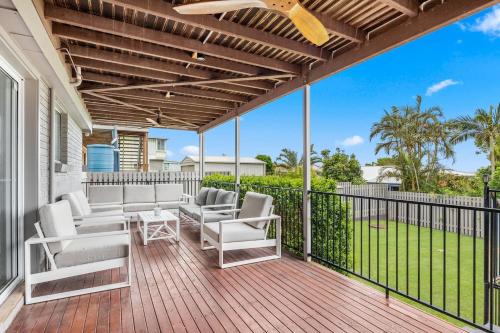 a deck with chairs and a table on a house at Hillcrest House - A Poolside Retreat on the Coast in Hervey Bay