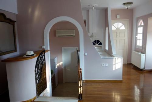 a room with a hallway with a staircase and a door at Villa Dendron in Aghia Marina