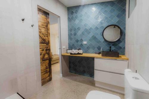 une salle de bain avec un lavabo et un miroir et des toilettes dans l'établissement Kookaburra Cottage, à North Arm