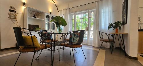 a dining room with chairs and a table with plants at Ground Floor Apartment near Pereybere Beach in Pereybere