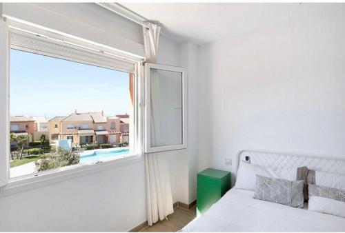 a bedroom with a bed and a large window at Paraíso zahara in Zahara de los Atunes