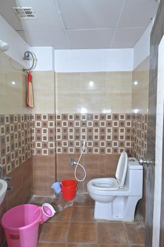 a bathroom with a toilet and a sink at Anyhour Stay in Gannavaram