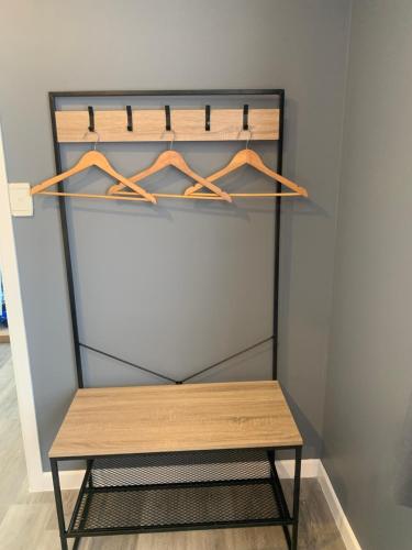 a shelf with a wooden bench in a closet at Bridge Pa cottage in Pakipaki