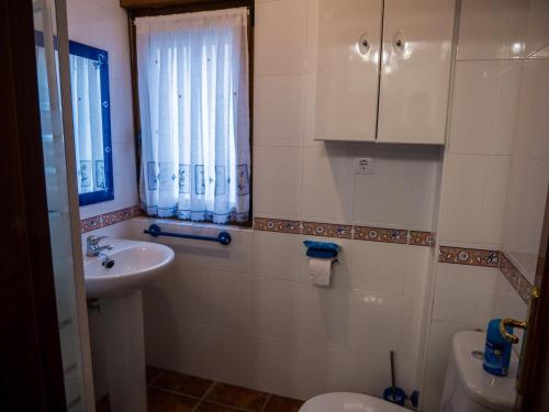 a bathroom with a sink and a toilet and a window at Large Villa in Cantabria in Arnuero