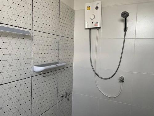 een douche in een wit betegelde badkamer met een slang bij RB5: PrivateHouse 8pax,chatuchak,mrt,jodd fair in Ban Zong Katiam