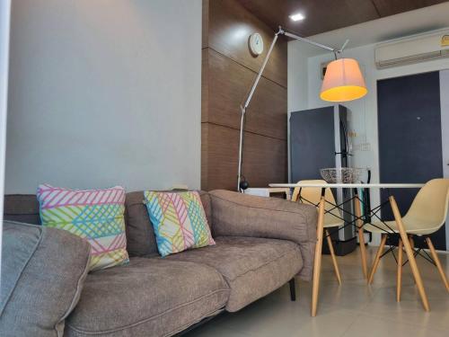 a living room with a couch and a table at Grandblue condominium 205 in Ban Tha Fat