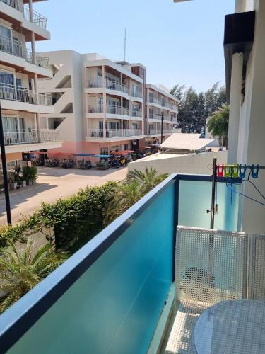 a view of the pool from the balcony of a apartment at Grandblue condominium 205 in Ban Tha Fat