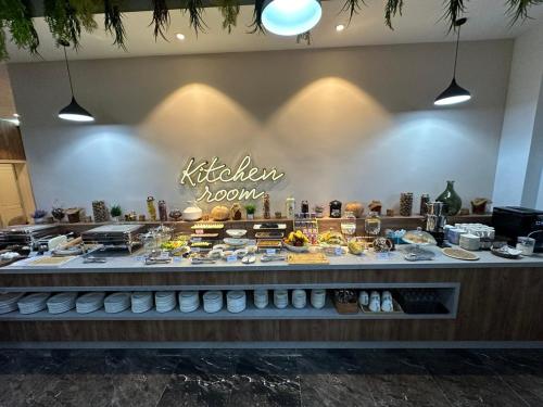a kitchen with a counter with food on it at IsraHotel Dushanbe in Dushanbe