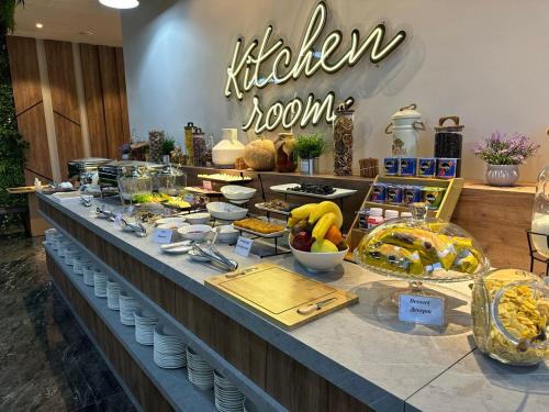 a buffet line with food on display in a store at IsraHotel Dushanbe in Dushanbe