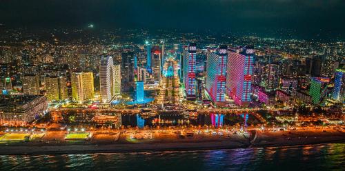 a view of a city at night with lights at Orbi City Hotel VIP - Batumi in Batumi