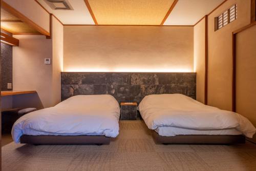 Un ou plusieurs lits dans un hébergement de l'établissement Jinya Ryokan