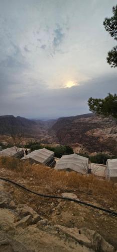 a view of the mountains from a hill with tents at Dana Village lodge and Camp-Wadi Dana Eco camp in Dana