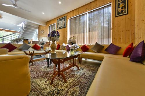 a living room with couches and a table at hotel pearl continental in Srinagar