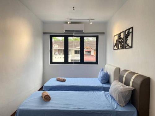 a bedroom with two beds and a window at Modern Cozy House 4 ROOM 10pax@Bukit Mertajam in Bukit Mertajam