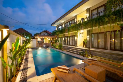 a swimming pool in the backyard of a house at Sleepwell Seminyak in Seminyak