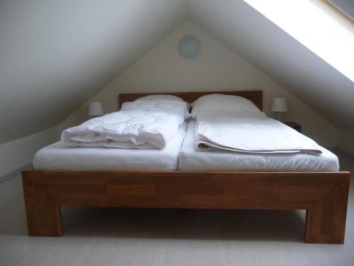 a bed in a attic with two pillows on it at Ferienhaus Molly in Zinnowitz