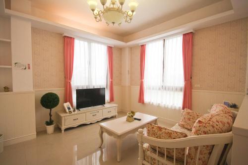 ein Wohnzimmer mit Sofa und Fernseher in der Unterkunft 城市角落民宿 in Hualien