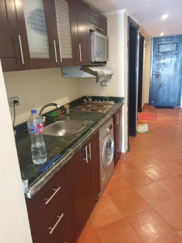 a kitchen with a sink and a stove top oven at شاليه فندقي بورتو مارينا الساحل الشمالي in El Alamein