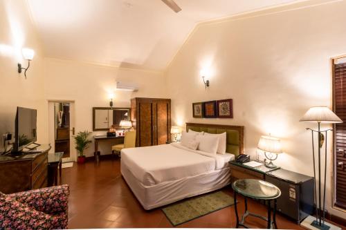a bedroom with a bed and a living room at Residency Lake Resort & Spa in Mulshi