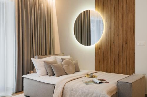 a bedroom with a large bed with a mirror at Muse - LoftAffair Spa Collection in Kraków