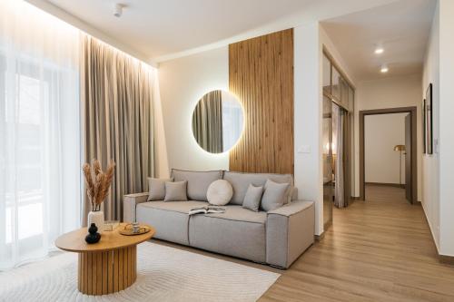 a living room with a couch and a table at Muse - LoftAffair Spa Collection in Kraków